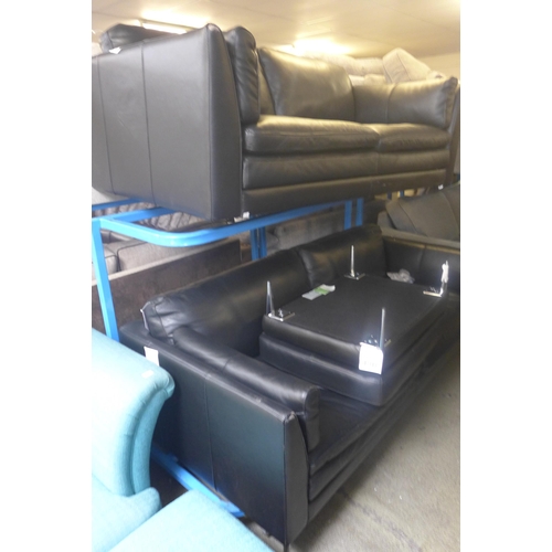 1744 - A black leather effect two seater, three seater sofa and footstool (two seater missing legs, both wo... 