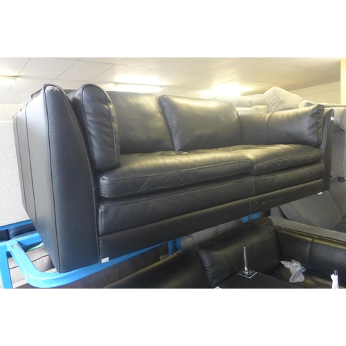 1744 - A black leather effect two seater, three seater sofa and footstool (two seater missing legs, both wo... 