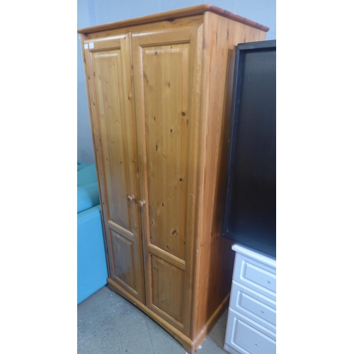 1768 - A pine two door full hanging wardrobe