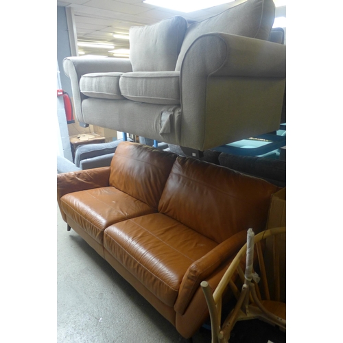 1779 - A light grey upholstered two seater sofa and a tan leather effect three seater sofa (both with damag... 