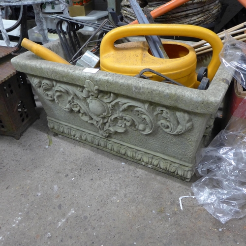 2402 - Stone planter with qty. of plastic and wicker baskets & gardening tools