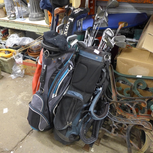 2403 - 4 golf bags with approx 30 golf clubs