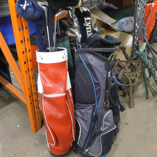 2403 - 4 golf bags with approx 30 golf clubs