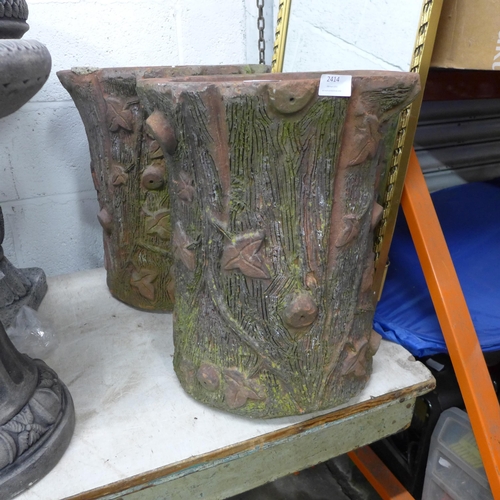 2414 - A pair of 18 inch high clay planters