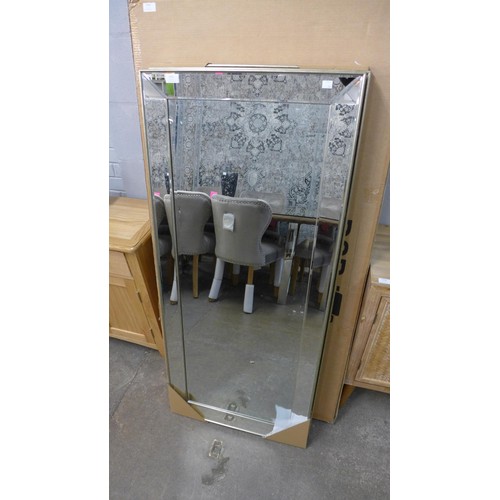 1999 - A rectangular mirror with metal framing  *This lot is subject to VAT