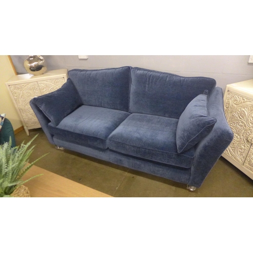 1364 - A deep ocean blue velvet three seater sofa on turned legs and castors