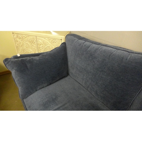 1364 - A deep ocean blue velvet three seater sofa on turned legs and castors