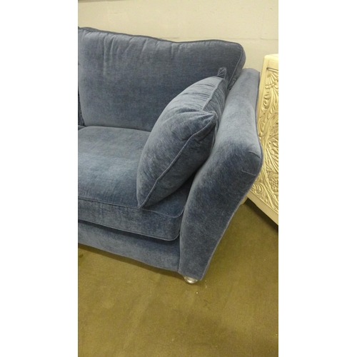 1364 - A deep ocean blue velvet three seater sofa on turned legs and castors