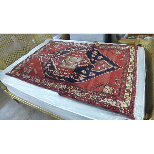 1439 - A red ground Persian Hamadan runner 292 x 114cm