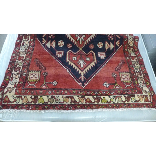 1439 - A red ground Persian Hamadan runner 292 x 114cm