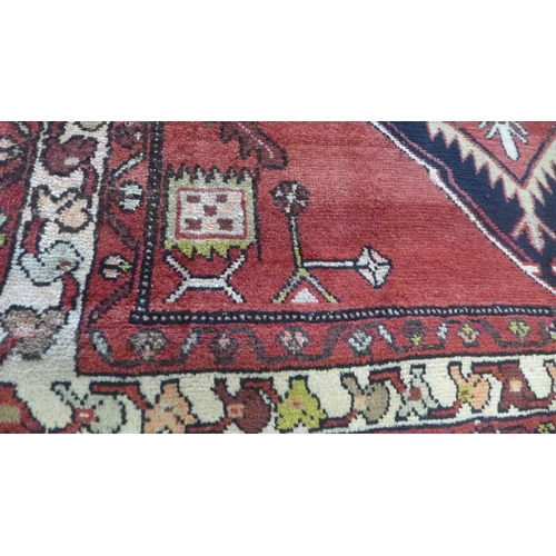 1439 - A red ground Persian Hamadan runner 292 x 114cm