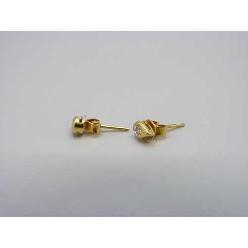 1094 - A pair of 18ct gold and diamond stud earrings, 1.2g