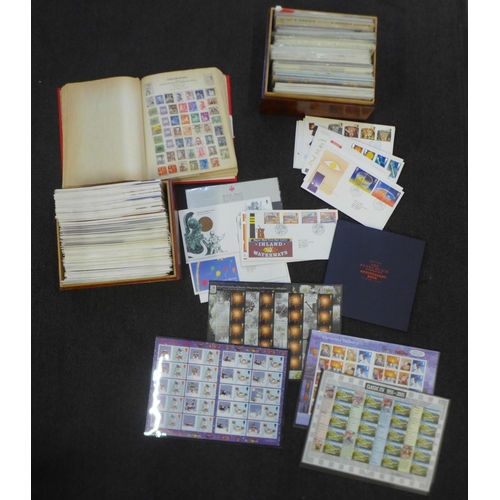 720 - A box of first day covers, mint postage stamps and an album of stamps