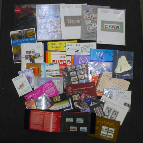 723 - Stamps; a box of assorted year books (5 Canada), presentation packs, etc.