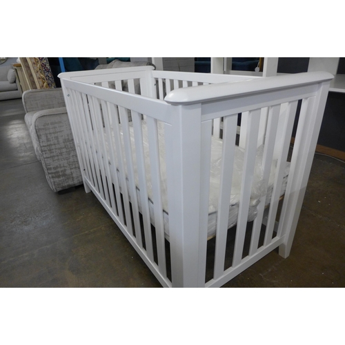 1595 - A white painted cot bed with mattress * this lot is subject to VAT