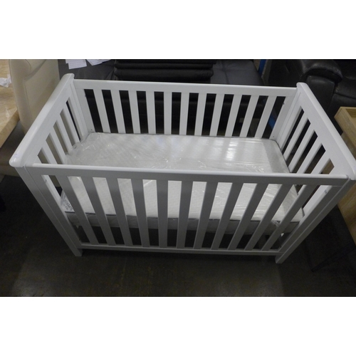 1595 - A white painted cot bed with mattress * this lot is subject to VAT