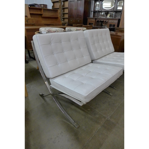 107 - A pair of Barcelona style chrome and white leather lounge chairs