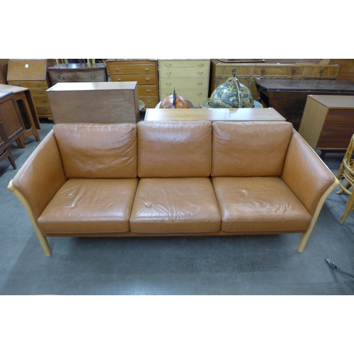 115 - A Danish Skalma beech and tan leather settee