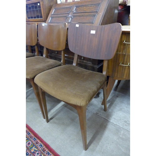 141 - A set of four teak dining chairs