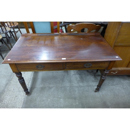 151 - A Victorian mahogany two drawer writing table