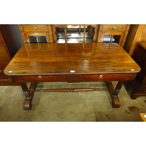 157 - A Regency rosewood two drawer library table