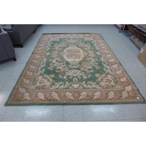 170 - A large green ground rug, 331 x 240cms