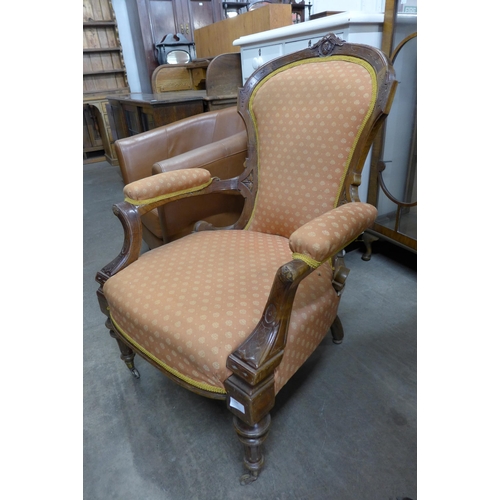 190 - A Victorian carved walnut and fabric upholstered armchair