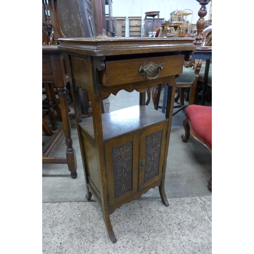 213 - An Edward VII carved oak smokers cabinet