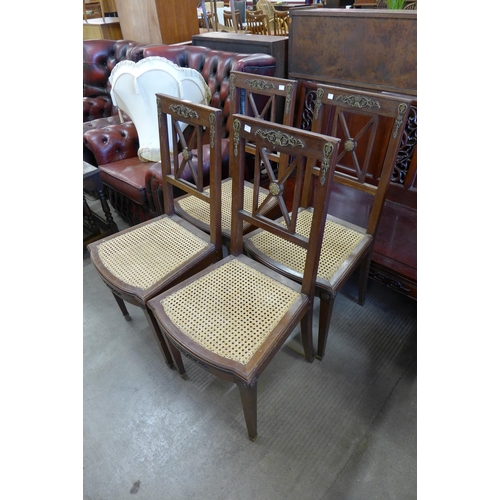 223 - A set of four French Empire style mahogany and gilt metal mounted chairs