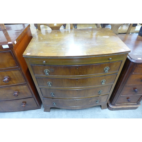 242 - A George III style walnut bow front chest of drawers