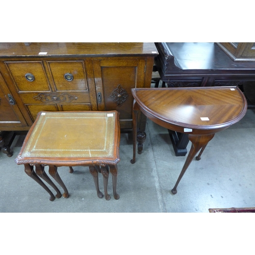 255 - A mahogany and leather topped nest of tables and a mahogany demi-lune hall table