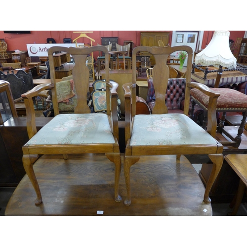 301 - A Queen Anne style burr walnut extending dining table and six chairs