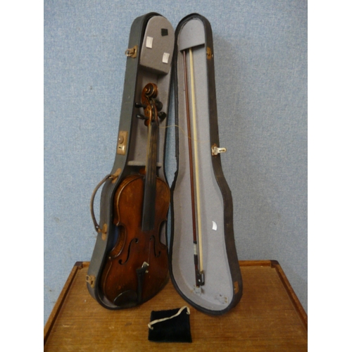 453 - A cased violin with bow, 38cm long (including button)