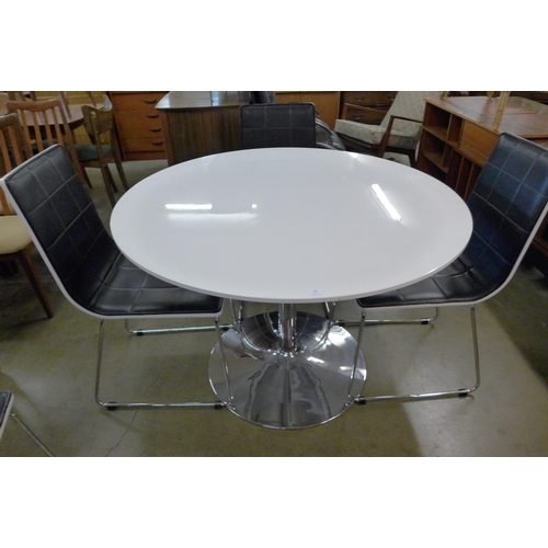 83 - A chrome and white laminate circular table, four chairs and a trolley