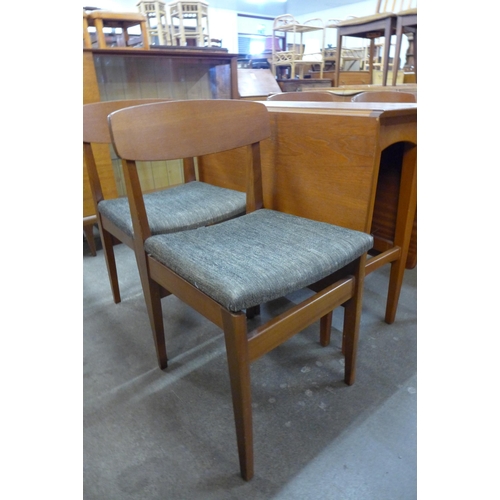 91 - A teak drop-leaf table and four chairs