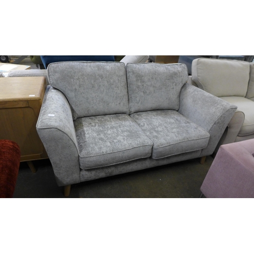 1529 - A pewter velvet two seater sofa with leg rest option