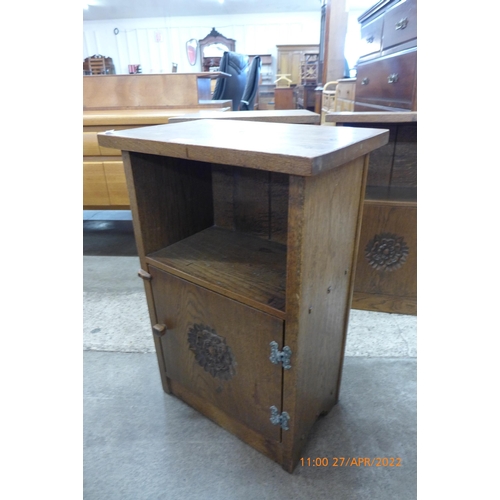 126 - A set of three Cotswold School carved oak pot cupboards