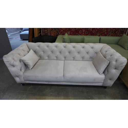 1535 - A light stone velvet Chesterfield three seater sofa