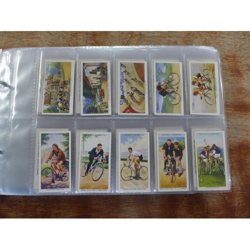 667 - Cigarette cards; an album of cigarette and trade cards containing thirteen complete sets