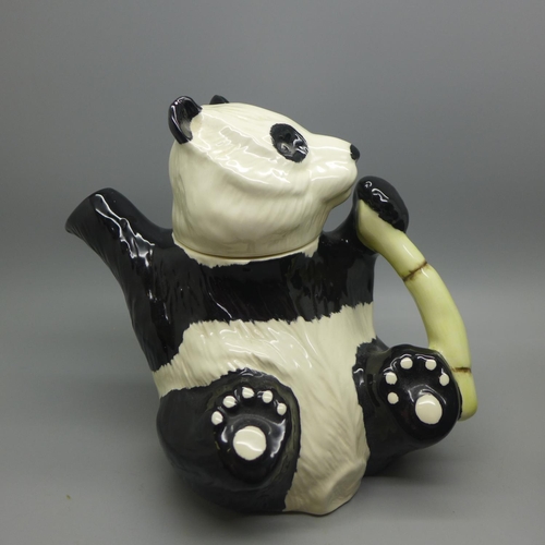 695 - A Beswick panda teapot and a Carlton Ware policeman teapot, chip to base