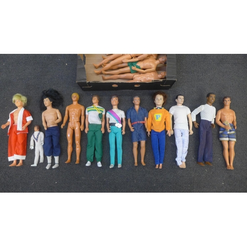 753 - A box of sixteen boy dolls including Paul with rooted hair