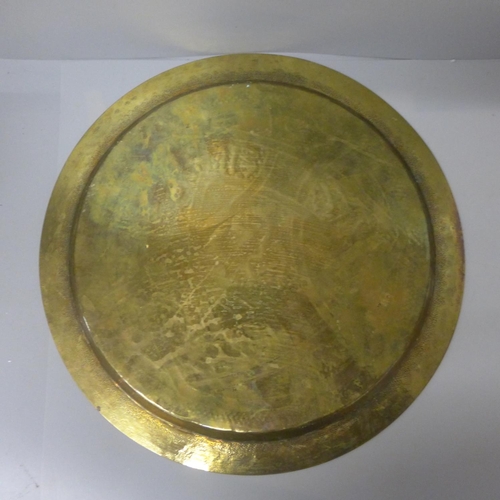 802 - A brass tray with Arabic decoration in copper and white metal, 34cm