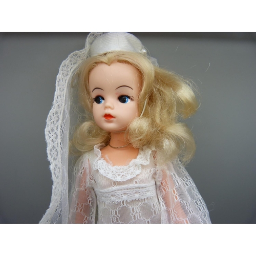 834 - A 1970's Sindy in bridal outfit with shoes, on stand