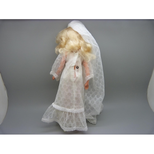 834 - A 1970's Sindy in bridal outfit with shoes, on stand