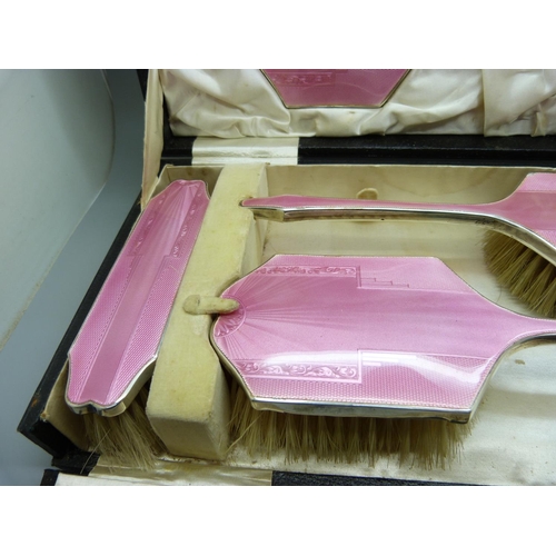 837 - An Art Deco silver and pink enamel dressing table set, cased, Birmingham 1936, W.G. Sothers Ltd., (n... 