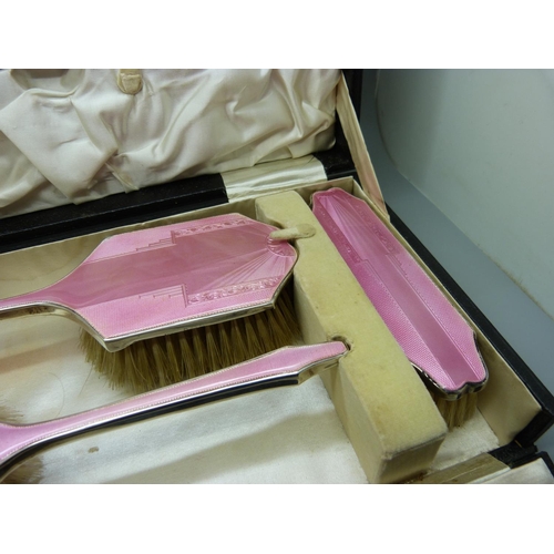 837 - An Art Deco silver and pink enamel dressing table set, cased, Birmingham 1936, W.G. Sothers Ltd., (n... 