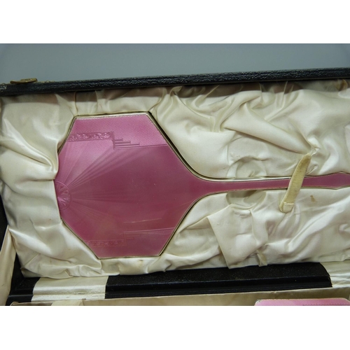 837 - An Art Deco silver and pink enamel dressing table set, cased, Birmingham 1936, W.G. Sothers Ltd., (n... 