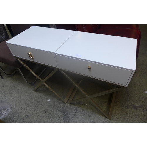 1587 - A pair of white bedside tables with cross legs