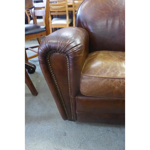 1607 - A brown leather two seater sofa