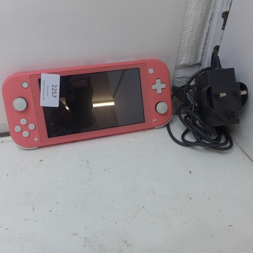 2257 - Nintendo Switch in light coral pink with charger and 2 games - W